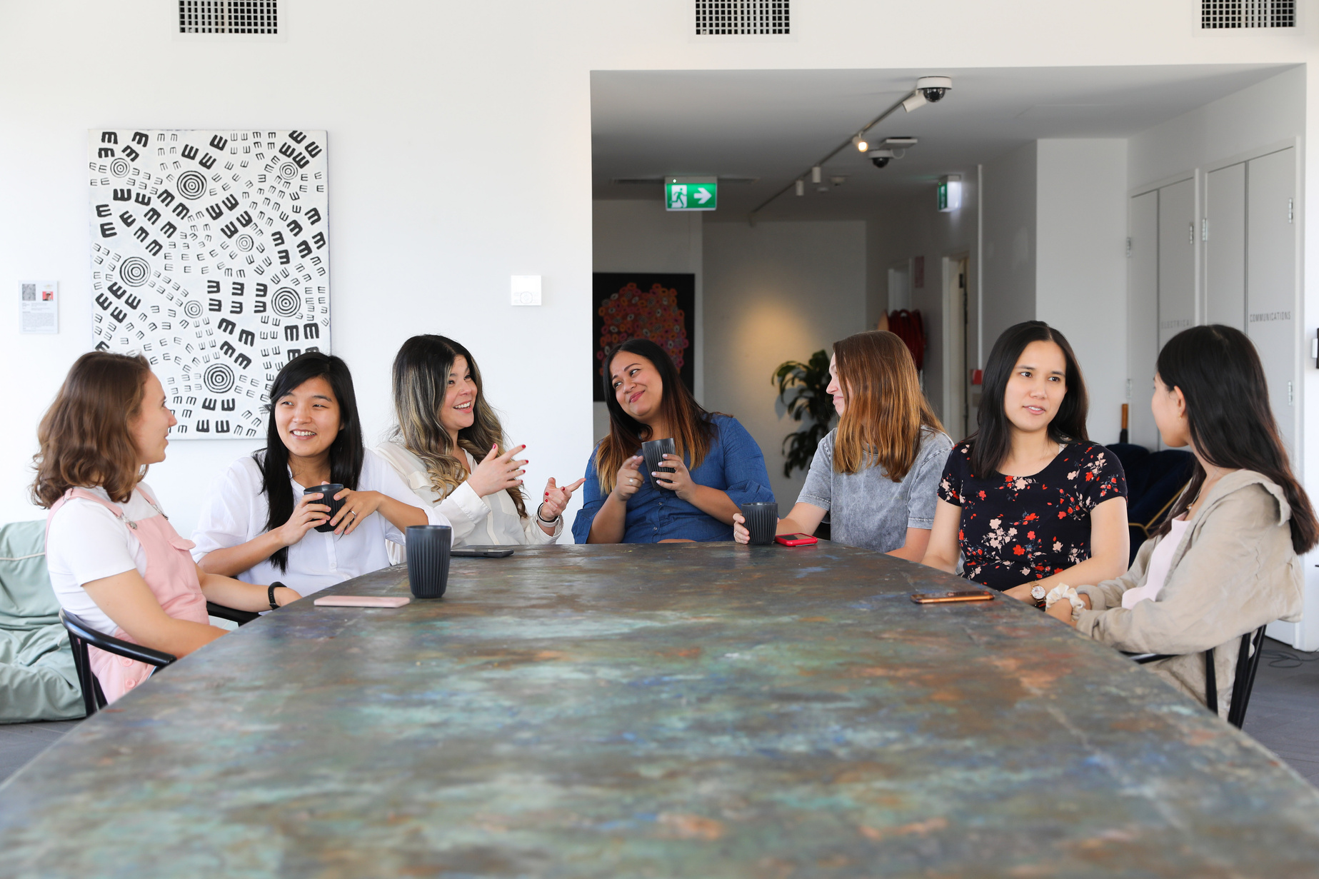 Women talking over coffee in the office